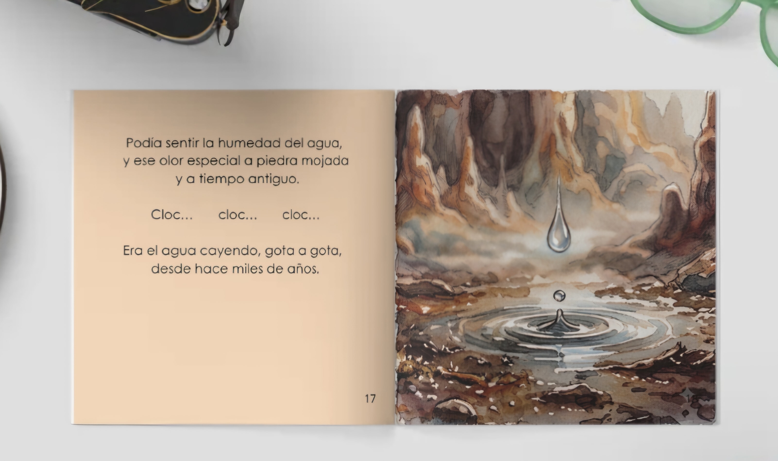 Libro infantil abierto con una escena de cueva